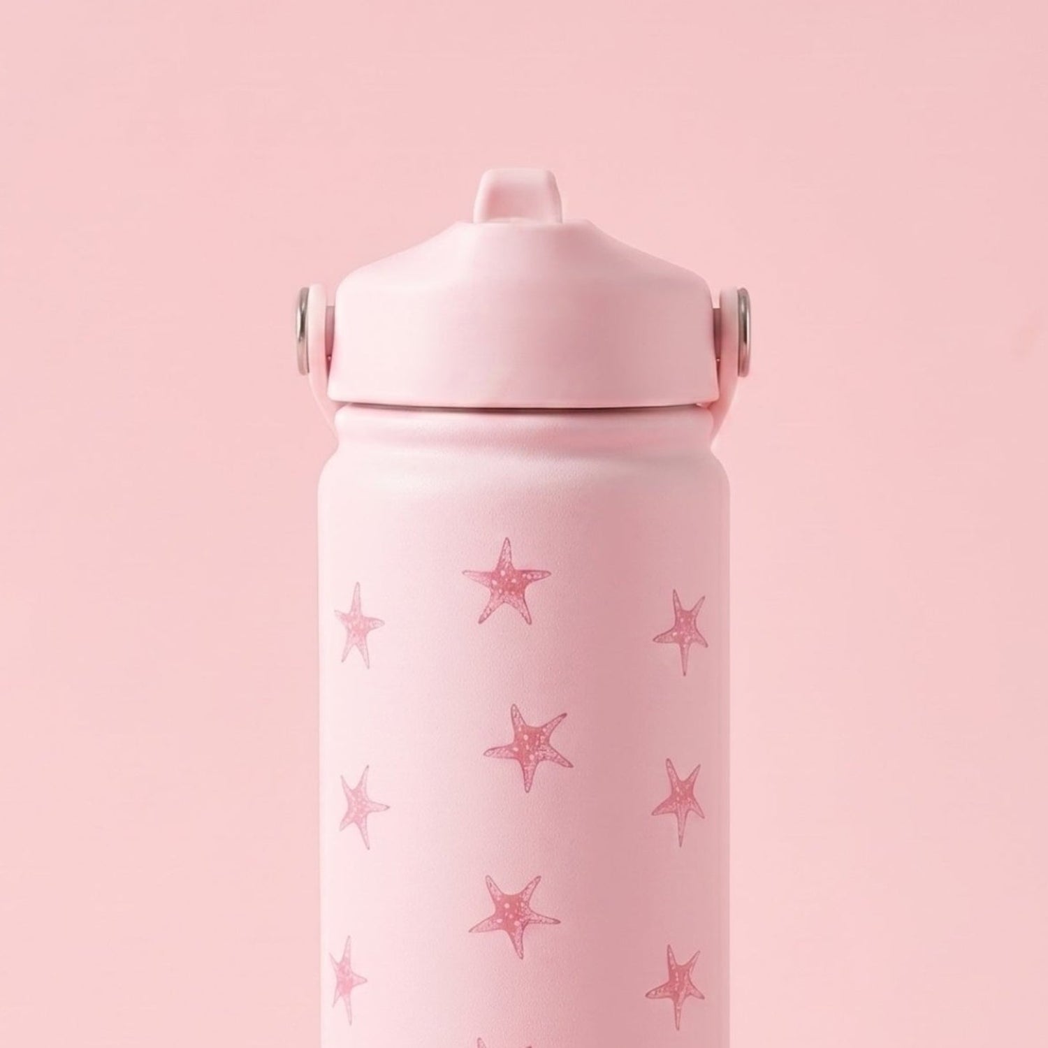 Pink water bottle with star pattern on a pink background